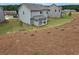 New construction backyard with covered patio and freshly seeded landscaping, grey siding at 702 Bristol Dr, Loganville, GA 30052