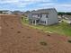New construction backyard features a partially landscaped yard and a covered patio at 702 Bristol Dr, Loganville, GA 30052