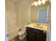 Bathroom with shower-tub combo, toilet, vanity with sink, and dark cabinets at 702 Bristol Dr, Loganville, GA 30052