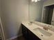 Bathroom features double sink vanity with modern fixtures and large mirror at 702 Bristol Dr, Loganville, GA 30052