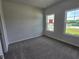 Carpeted bedroom with two windows providing ample natural light at 702 Bristol Dr, Loganville, GA 30052