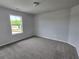 Neutral bedroom with carpet, light walls, and natural light from window at 702 Bristol Dr, Loganville, GA 30052