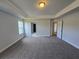 Bedroom features carpet, neutral paint, tray ceiling and natural light at 702 Bristol Dr, Loganville, GA 30052