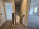 Upstairs hallway features plush carpeting and views into bedrooms at 702 Bristol Dr, Loganville, GA 30052