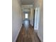 Hallway with wood floors leading to living area with natural lighting at 702 Bristol Dr, Loganville, GA 30052