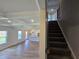 Open floor plan with living room, stairs, and kitchen with island for seamless living at 702 Bristol Dr, Loganville, GA 30052