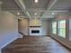 Bright living room features coffered ceilings, fireplace, wood floors and natural light at 702 Bristol Dr, Loganville, GA 30052