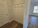 Mudroom area with hooks, wood floors and molding detail at 702 Bristol Dr, Loganville, GA 30052
