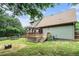 Beautiful backyard with a wooden deck and pergola, fire pit, and wooded backdrop at 1235 Waterwood Dr, Loganville, GA 30052
