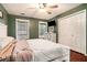 Comfortable bedroom featuring a cozy queen bed, modern ceiling fan, and view of the backyard at 1235 Waterwood Dr, Loganville, GA 30052