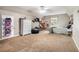 Bright bedroom with neutral carpet, large dresser, a ceiling fan, and open space at 1235 Waterwood Dr, Loganville, GA 30052