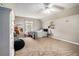 Bedroom with a ceiling fan, neutral carpet, bright window, dresser, and a bed at 1235 Waterwood Dr, Loganville, GA 30052