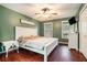 Charming bedroom with a white bed set, modern ceiling fan and light, and windows overlooking the yard at 1235 Waterwood Dr, Loganville, GA 30052