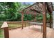 Relaxing backyard deck with wooden pergola, ideal for outdoor dining and gatherings at 1235 Waterwood Dr, Loganville, GA 30052