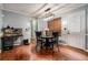 Charming dining room with wood floors, table and view to kitchen at 1235 Waterwood Dr, Loganville, GA 30052