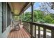 Cozy covered front porch with rocking chairs and a serene neighborhood view at 1235 Waterwood Dr, Loganville, GA 30052