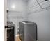 Laundry room featuring a modern washing machine and dryer with convenient shelving at 1235 Waterwood Dr, Loganville, GA 30052