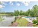 Stunning aerial view of the backyard, showcasing a pool, lake, lush landscaping and golf course in the background at 3718 Lake Vis, Douglasville, GA 30135