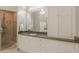 A vanity with a light countertop sits next to the walk-in shower in this well lit bathroom at 3718 Lake Vis, Douglasville, GA 30135