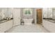 This bathroom offers double vanities, a soaking tub, and a glass enclosed shower, perfect for relaxation at 3718 Lake Vis, Douglasville, GA 30135