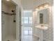 Bathroom showcasing a patterned wall, pedestal sink, and a tiled shower with glass door at 3718 Lake Vis, Douglasville, GA 30135