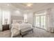 This primary bedroom features a luxurious upholstered headboard, trey ceiling, and access to a private balcony at 3718 Lake Vis, Douglasville, GA 30135