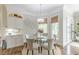 Bright dining area features a round glass table, six chairs, and a bay window with natural light at 3718 Lake Vis, Douglasville, GA 30135