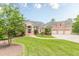 Stately brick home with a manicured lawn and a three-car garage, complete with lush landscaping and an inviting entrance at 3718 Lake Vis, Douglasville, GA 30135