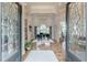 View from double front doors into a grand foyer with hardwood floors and a grand piano at 3718 Lake Vis, Douglasville, GA 30135