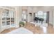 Open foyer with hardwood floors, a grand piano near arched windows, and a view into an office at 3718 Lake Vis, Douglasville, GA 30135