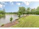 Expansive lake view with meticulously manicured lawn and landscaping creates a serene outdoor ambiance at 3718 Lake Vis, Douglasville, GA 30135