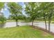 A tranquil lake view with mature shade trees makes for a peaceful backyard retreat at 3718 Lake Vis, Douglasville, GA 30135