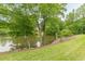 Lush landscaping on the lake shore adds to the beauty of this scenic backyard at 3718 Lake Vis, Douglasville, GA 30135