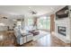 Inviting living room featuring hardwood floors, a fireplace, and a view of the lake and outdoor area at 3718 Lake Vis, Douglasville, GA 30135