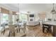 Open-concept living and dining area with hardwood floors, large windows, and a cozy fireplace at 3718 Lake Vis, Douglasville, GA 30135