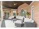 Inviting outdoor patio with brick accents, comfortable seating, and ceiling fan for relaxed living at 3718 Lake Vis, Douglasville, GA 30135