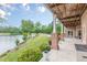 Covered brick patio featuring an outdoor kitchen overlooks the lake, perfect for entertaining guests at 3718 Lake Vis, Douglasville, GA 30135