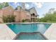Pool with a waterfall feature and patio. A luxury home is in the background at 3718 Lake Vis, Douglasville, GA 30135