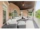 This spacious covered porch features brick accents, comfortable seating, and views of the property's landscaping at 3718 Lake Vis, Douglasville, GA 30135
