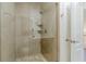 Modern shower with glass door, neutral tile, shower head, and corner shelves at 3718 Lake Vis, Douglasville, GA 30135
