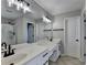 Bathroom featuring double sink, mirrors and shower with black hardware and plenty of light at 595 Stonepark Ln, Suwanee, GA 30024