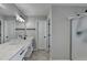 Bathroom featuring double sink, mirrors and shower with black hardware and plenty of light at 595 Stonepark Ln, Suwanee, GA 30024