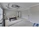 Spacious bedroom featuring a tray ceiling, carpeted floor, and ample natural light from windows at 595 Stonepark Ln, Suwanee, GA 30024