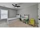 Airy bedroom with a large window, desk, and ceiling fan at 595 Stonepark Ln, Suwanee, GA 30024
