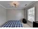 Bedroom featuring a cozy setup with a blue bed, a storage unit, and natural light from the window at 595 Stonepark Ln, Suwanee, GA 30024