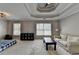 Bedroom with a tray ceiling, carpeted floor, and ample natural light from windows at 595 Stonepark Ln, Suwanee, GA 30024