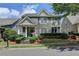 Charming two-story home with stone accents, landscaped front yard, and inviting covered porch at 595 Stonepark Ln, Suwanee, GA 30024