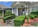 Inviting front porch with stone steps, manicured hedges, and classic white pillars and railings at 595 Stonepark Ln, Suwanee, GA 30024