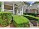 Manicured hedges and stone steps lead to the charming covered porch at 595 Stonepark Ln, Suwanee, GA 30024