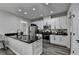 Bright kitchen features stainless steel appliances, granite countertops, and white cabinets at 595 Stonepark Ln, Suwanee, GA 30024